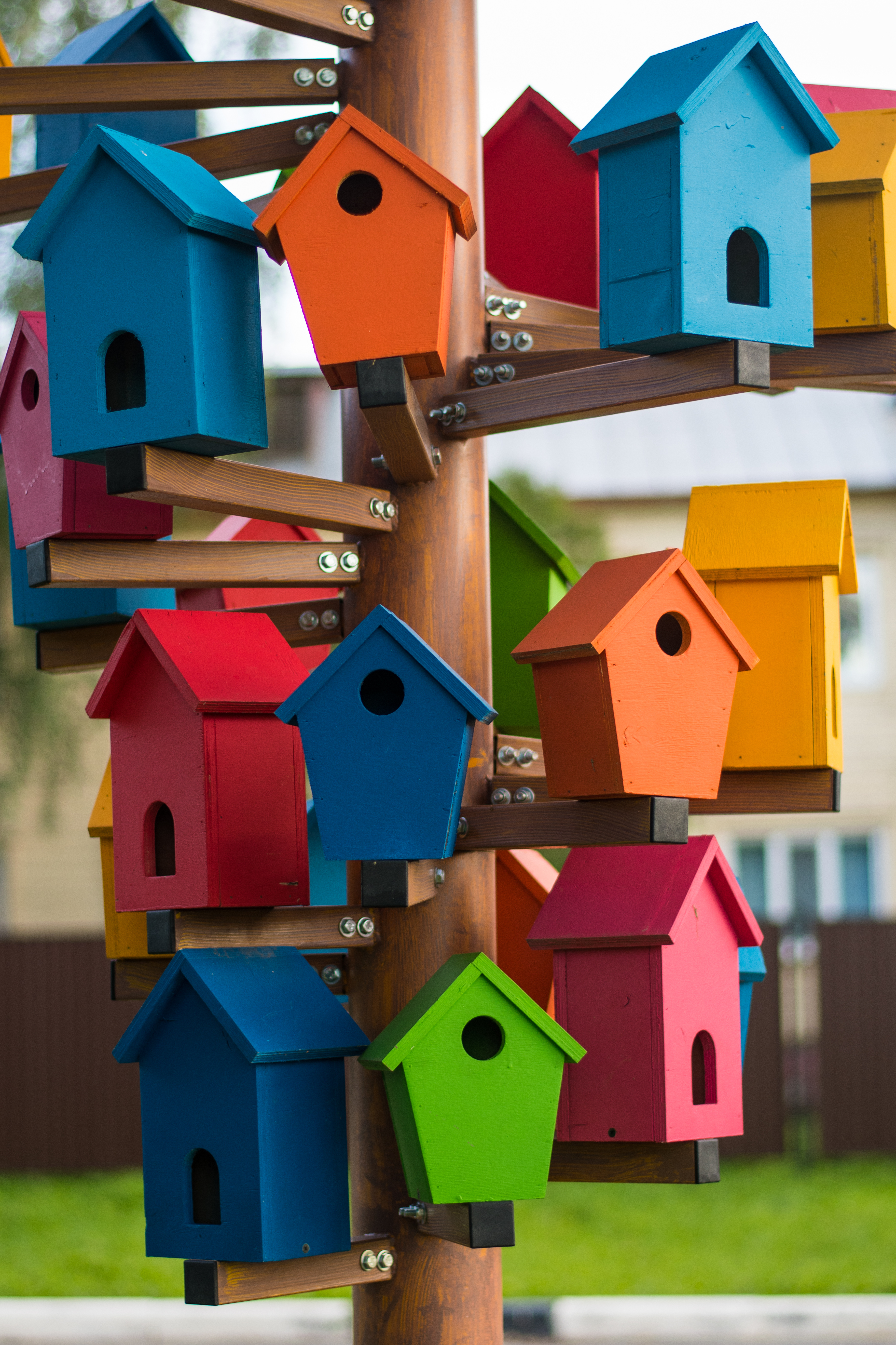 Assortment of colorful painted birdhouses.