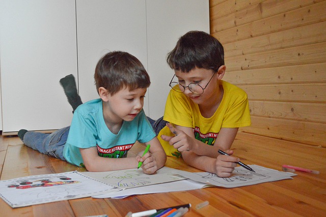 Two boys coloring on floor