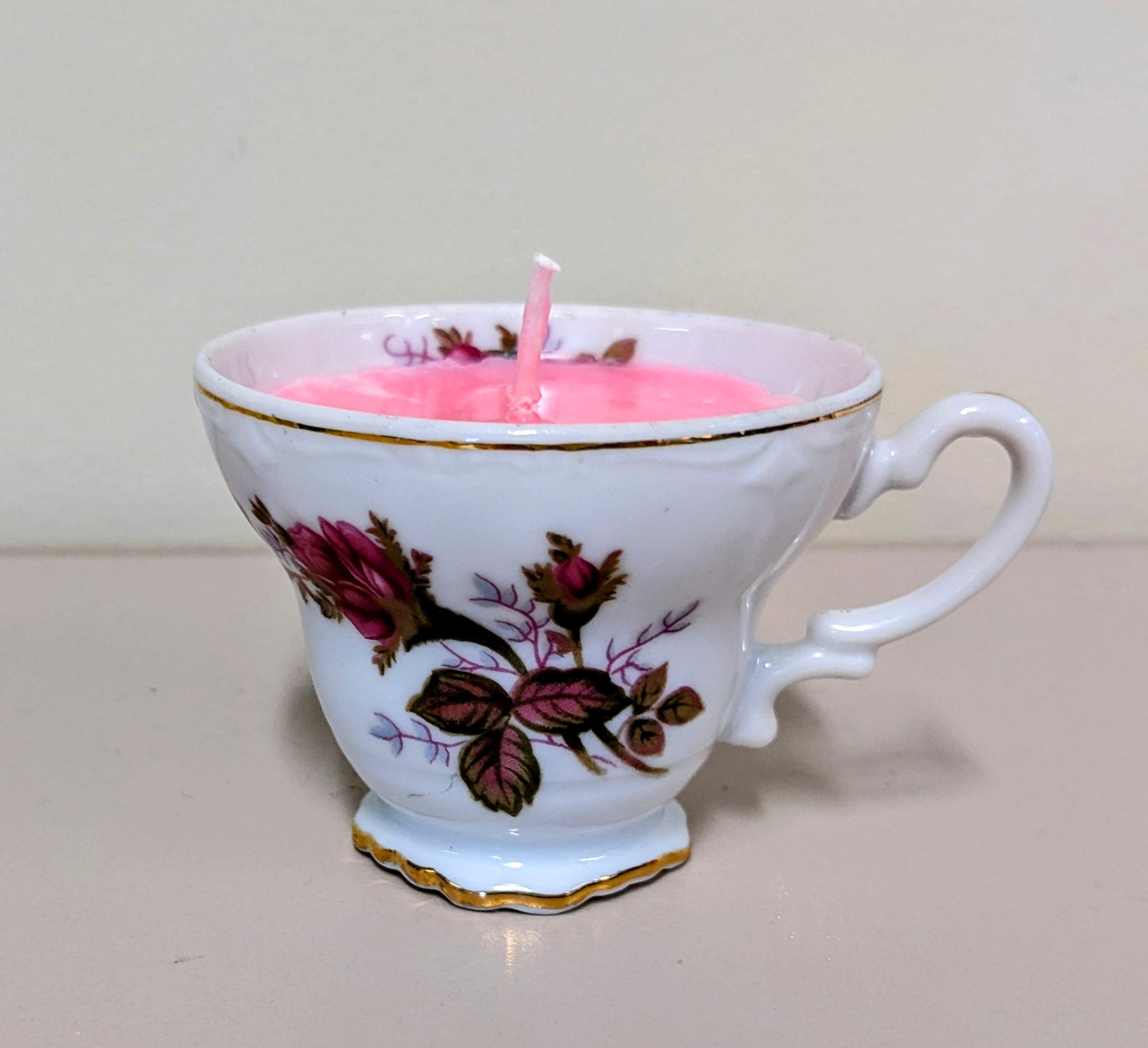 Pink candle in a small tea cup