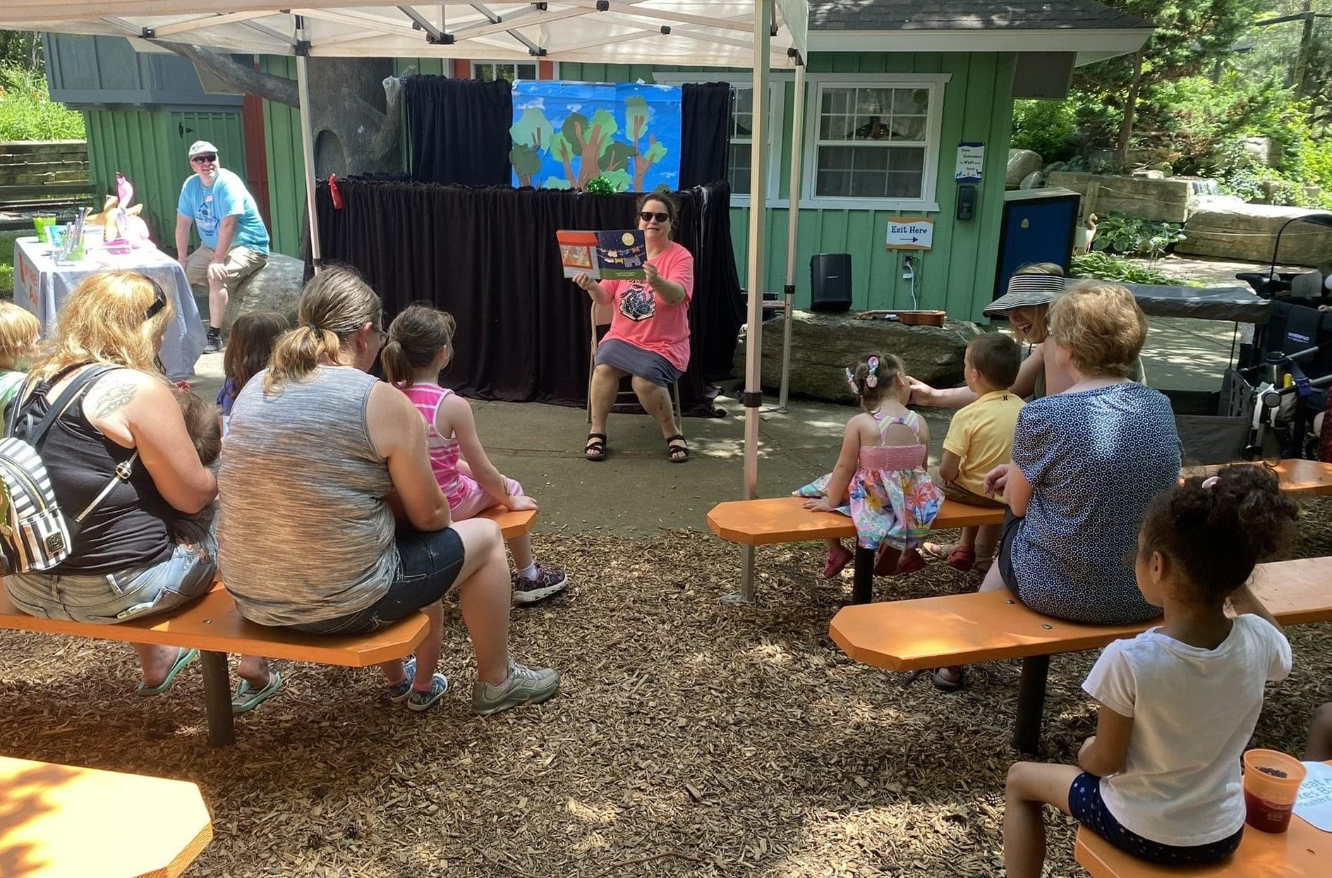 Miss Beth reads to the crowd at DEAR at the Zoo 2022