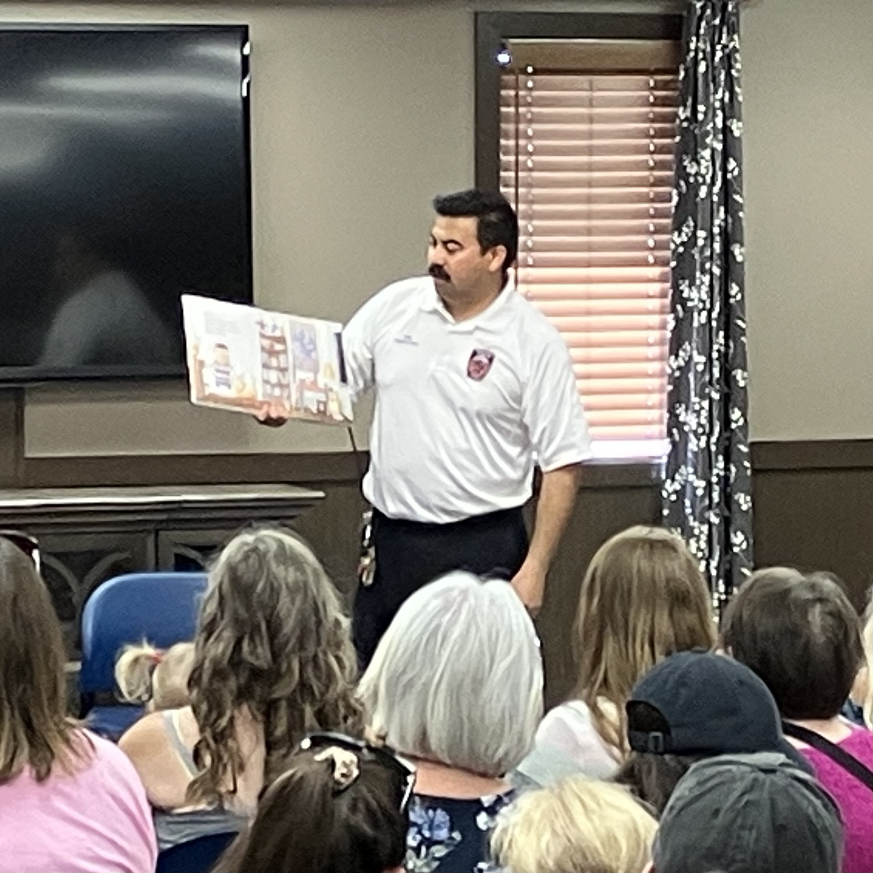 Firefighter Phil reading at storytime