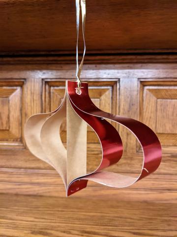 3 dimensional paper ornament hanging on the fireplace mantle.
