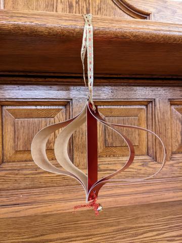 3 dimensional paper ornament hanging on the fireplace mantle.