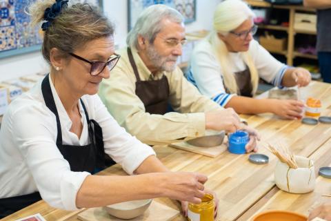 Photo of seniors painting pottery