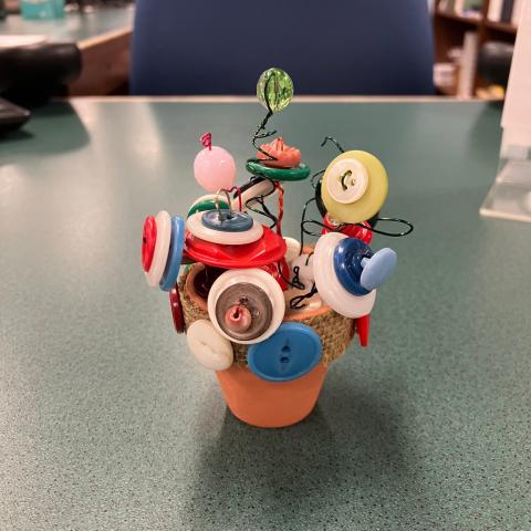 example of a Wired Button Flower project, showing a small flower pot with wire sticking up and buttons as the flowers