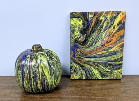 Pour painted pumpkin and canvas with Halloween colors (neon green, purple, orange, and black)