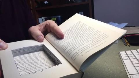A modified book with a cut-out inside to turn it into a box.