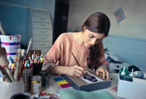 woman painting at a desk