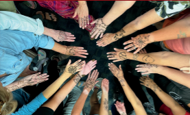 Circle of arms with henna designs