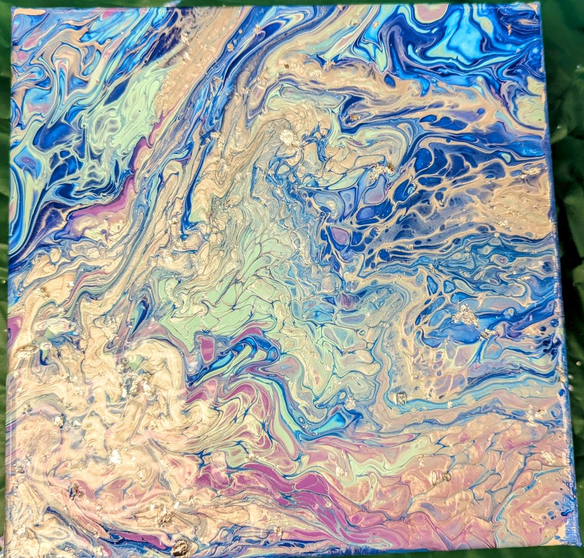 Pour painted canvas in silver, blue, aqua and purple with bits of silver foil sprinkled in.