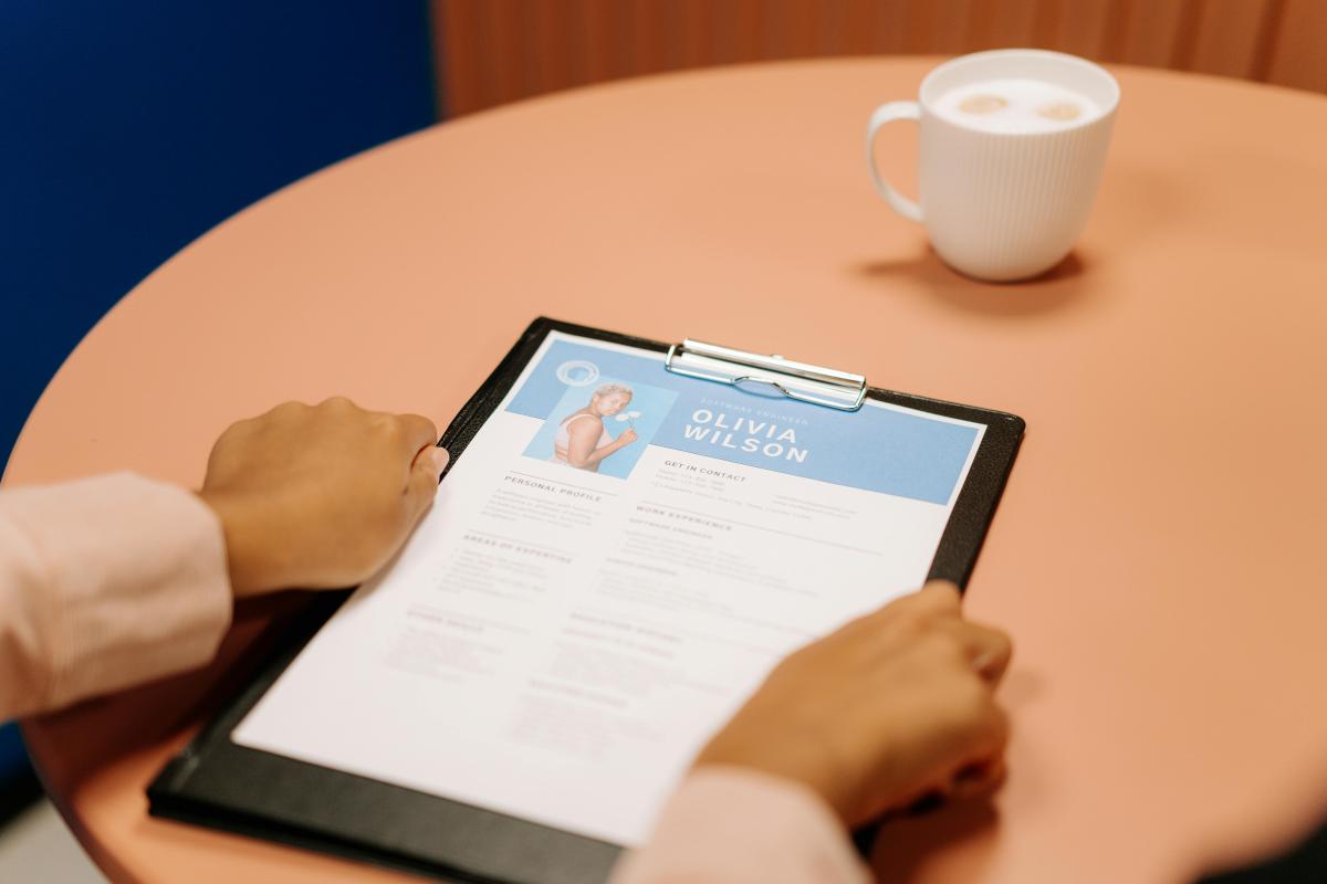 color photo of person holding a paper resume
